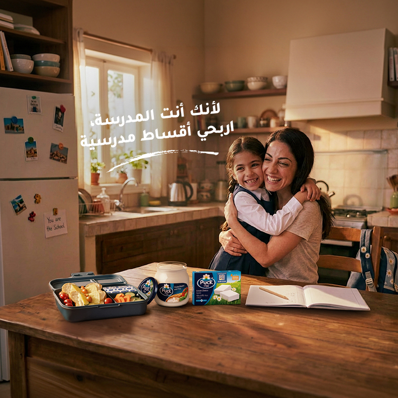 أم تحتضن ابنتها وبجانبهما اللانش بوكس المدرسي 